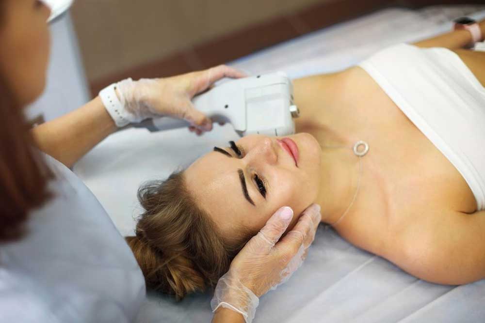 Woman receiving non-surgical V-Lifting HIFU skin tightening treatment for jawline and neck at a Dubai clinic